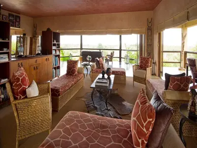 a living room with couches and a table at Makumu Private Game Lodge in Klaserie Private Nature Reserve