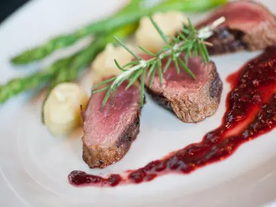 a plate of food with meat and vegetables on it at Makumu Private Game Lodge in Klaserie Private Nature Reserve