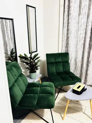 a living room with two green chairs and a table at Ts Group Africa furnished apartments - Marothwane Saturday Sebola in Pretoria