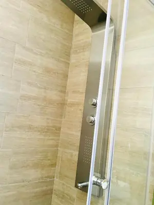 a shower with a glass door in a bathroom at Ts Group Africa furnished apartments - Marothwane Saturday Sebola in Pretoria