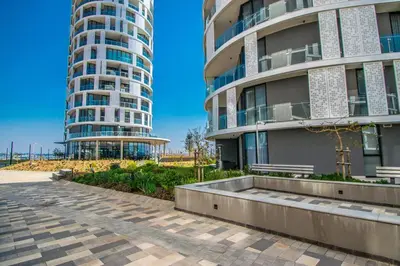 two tall buildings next to a sidewalk in front at Beautiful Galena at Ellipse in Midrand