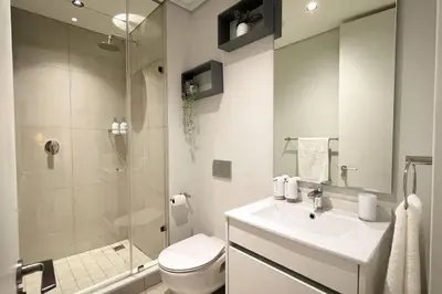 a bathroom with a toilet and a sink and a shower at Beautiful Galena at Ellipse in Midrand