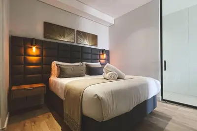 a bedroom with a large bed with two towels on it at Beautiful Galena at Ellipse in Midrand