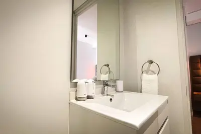 a white bathroom with a sink and a mirror at Beautiful Galena at Ellipse in Midrand
