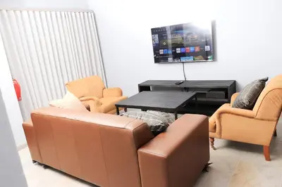 a living room with a couch and a table and chairs at Maranzhe Villa in Musina