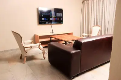 a living room with a couch and a table and chairs at Maranzhe Villa in Musina