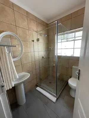 a bathroom with a shower and a sink and a toilet at Maranzhe Villa in Musina