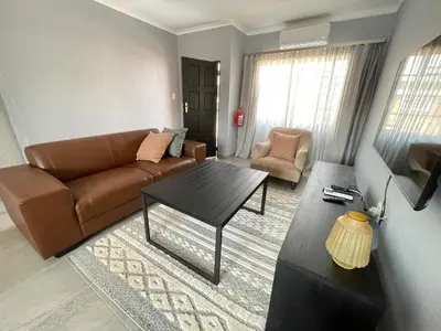 a living room with a couch and a coffee table at Maranzhe Villa in Musina