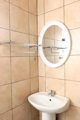 a bathroom with a sink and a mirror on the wall at Maranzhe Villa in Musina