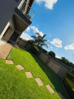 a grassy yard with a fence and a house at Villa De Gabe in Monavoni