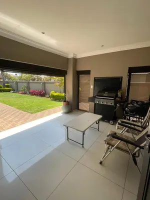 a living room with a table and a stove at Villa De Gabe in Monavoni