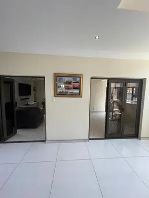 a room with glass doors and a white floor at Villa De Gabe in Monavoni