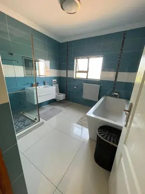 a bathroom with a tub and a sink and a shower at Villa De Gabe in Monavoni