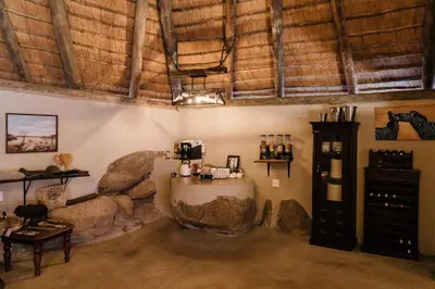 a room with a room with a stone wall at Timbila Game Lodge - Welcome to Land of Leopards and Buffalo in Phalaborwa
