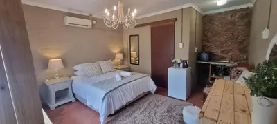 a bedroom with a bed and a chandelier at Die Windpomp Bosveld in Lephalale