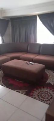 a brown couch sitting in a living room at View in in Nelspruit