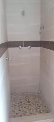 a bathroom with a shower with a tiled floor at View in in Nelspruit
