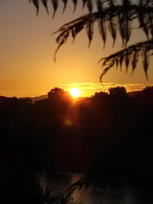 a sunset with the sun setting in the distance at Hennie's Rest in Malelane