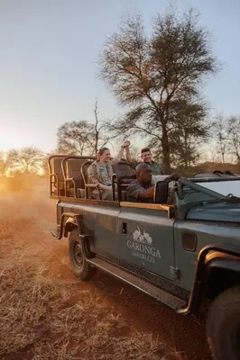 a group of people riding in the back of a jeep at Garonga Safari in Makalali Game Reserve