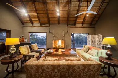 a living room with a couch and a table at Garonga Safari in Makalali Game Reserve