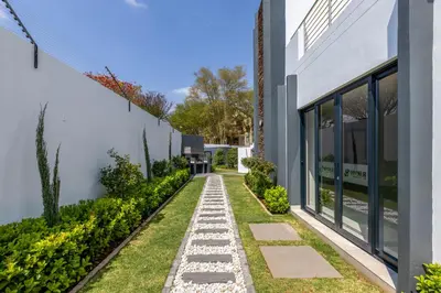 a garden with a walkway next to a building at Smartz Apartment in Erand