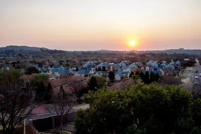 a view of a city at sunset at Time Oon-Travel & Tour Equestria Parkview in Pretoria