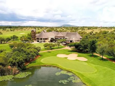 an aerial view of a golf course with a house at Zebula Golf and Wildlife Estate - Bushveld Bliss Pax 14 - Moi Signature Luxury villa in Mabula