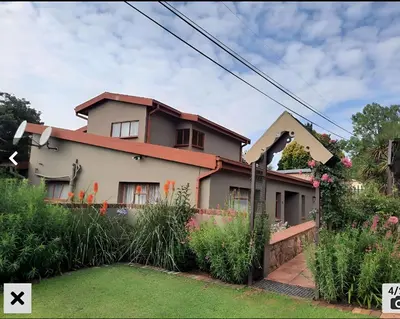 a house with a garden in front of it at Villa Tehillah in Dullstroom