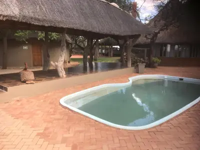 a swimming pool in the middle of a resort at Hayoma Lodge in Tshipise