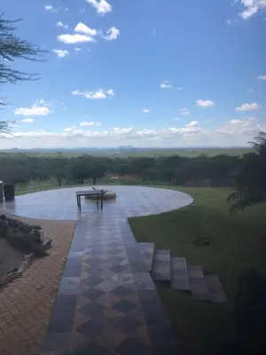 a picnic table sitting on top of a field at Hayoma Lodge in Tshipise