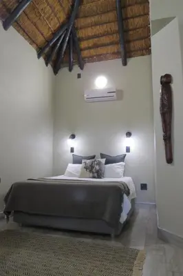 a bedroom with a large bed in a room at Hayoma Lodge in Tshipise