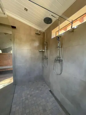 a bathroom with two shower heads on the wall at Vrede Luxury Tented Camp in Kosmos