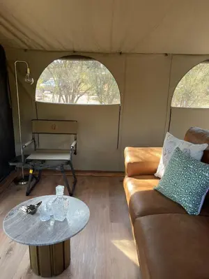 a living room with a couch and a table at Vrede Luxury Tented Camp in Kosmos