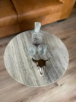a glass table with glasses and a vase on it at Vrede Luxury Tented Camp in Kosmos
