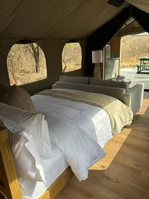a bedroom with a large bed in a tent at Vrede Luxury Tented Camp in Kosmos