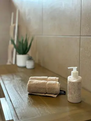 a bathroom counter with a towel and a bottle of soap at Vrede Luxury Tented Camp in Kosmos