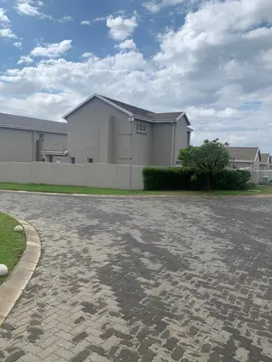 a driveway in front of a white house at Ore Private property in Midrand