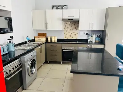 a kitchen with a stove and a dishwasher at Ore Private property in Midrand