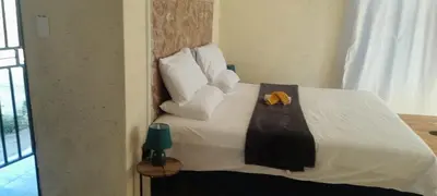 a bedroom with a bed with a yellow towel on it at PK house in Mbabat