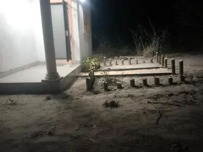 a cemetery in front of a building at night at PK house in Mbabat