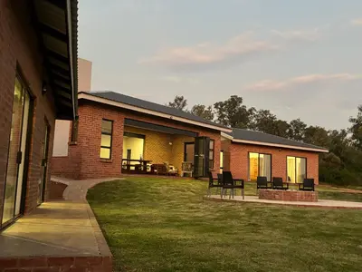 a brick house with a lawn in front of it at Elements Golfers Lodge 123 in Moheme