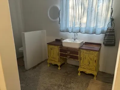 a bathroom with a sink and a window at Elements Golfers Lodge 123 in Moheme