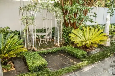 a garden with a gazebo and a table and chairs at Touch of Class Guest House in Pretoria