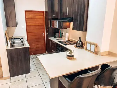 a kitchen with a sink and a counter top at Luxury Duplex in Pretoria East in Pretoria