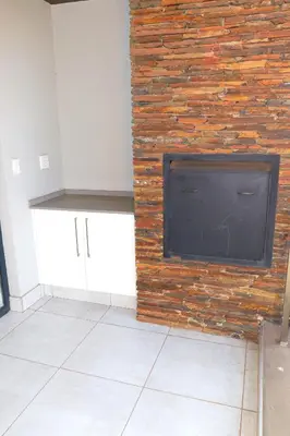 a flat screen tv mounted to a brick wall at The Thorn by the airport in Kempton Park