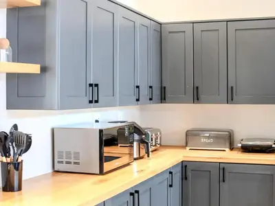a kitchen with gray cabinets and a silver appliance at Highland Peace Haven In Dullstroom in Dullstroom
