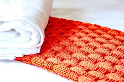 a person with a towel on top of a crochet rug at Highland Peace Haven In Dullstroom in Dullstroom