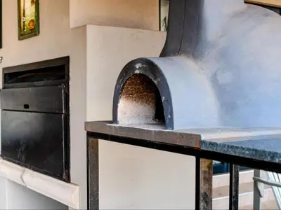 a pizza oven with some food inside of it at Highland Peace Haven In Dullstroom in Dullstroom