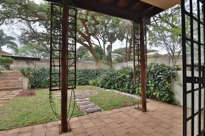 a swing in the middle of a garden at Crowley Cottage in White River