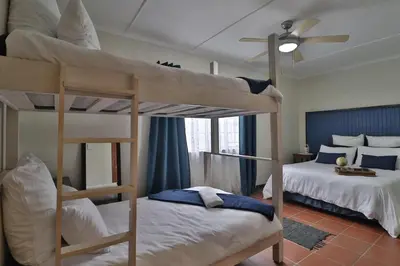 a bedroom with two bunk beds and a ceiling fan at Crowley Cottage in White River
